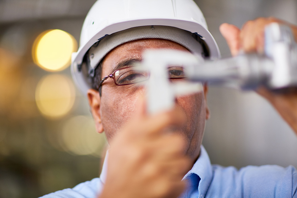 Engineer making a structural assessment measurement