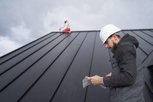 Engineer inspecting property and roof damage after a storm