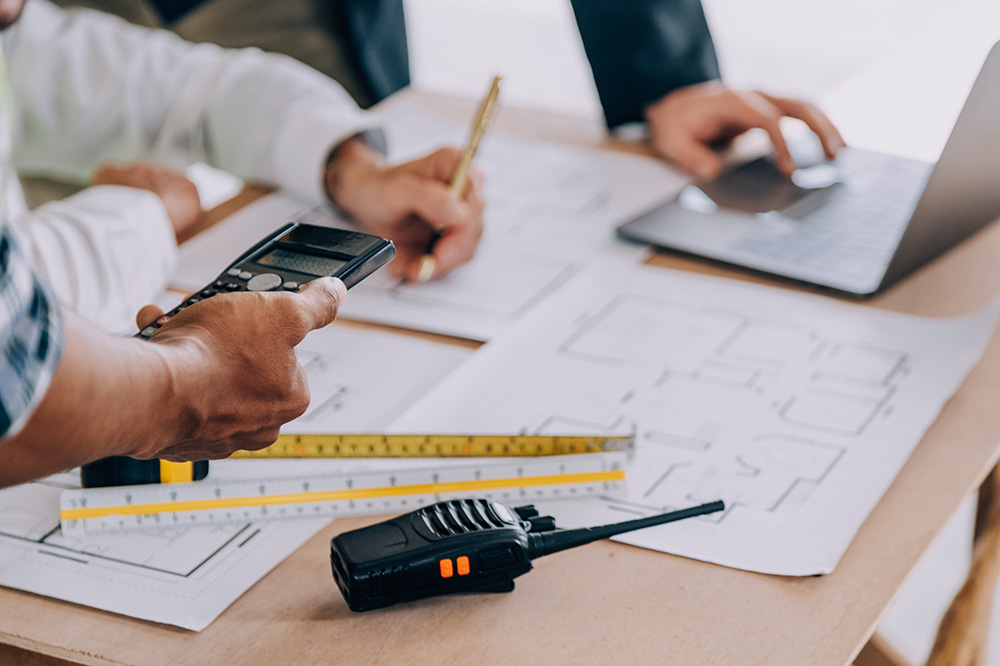 Quantity surveyors reviewing an insurance cost assessment and indemnity valuation